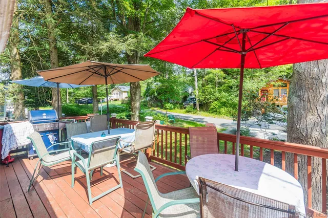 a view of a patio with a table and chairs under an umbrella