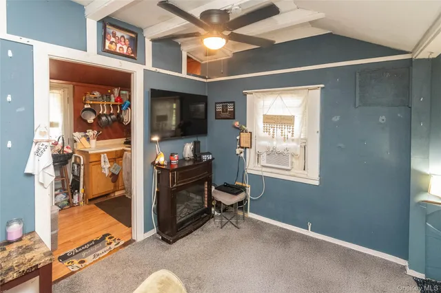 a view of a livingroom with workspace and a window
