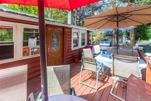 a view of a patio with table and chairs under an umbrella