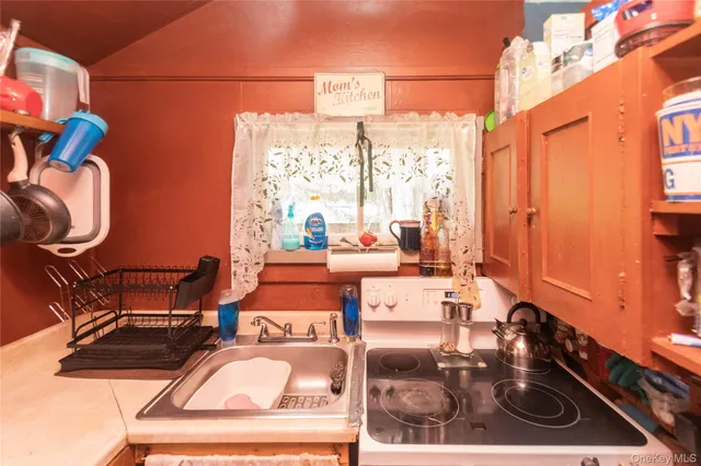 a living room with furniture a window and a chandelier