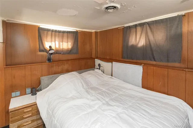 a bedroom with a bed and a mirror