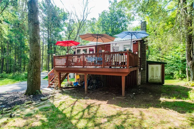 a view of a house with a yard porch and furniture