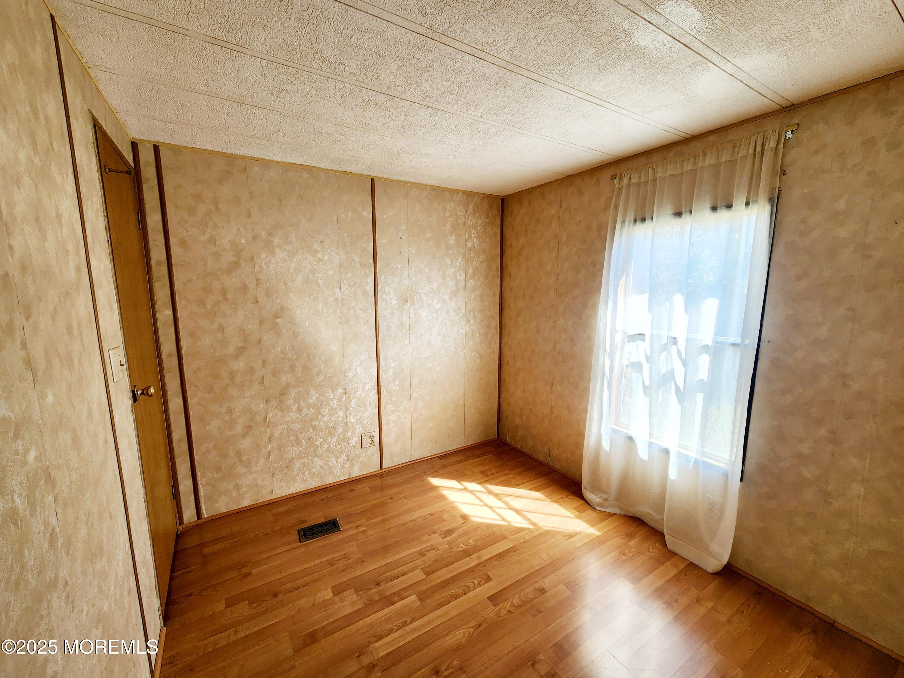 5 Fallow Drive Manalapan, NJ 07726 - Photo 12 of 23 a view of empty room with wooden floor and fan