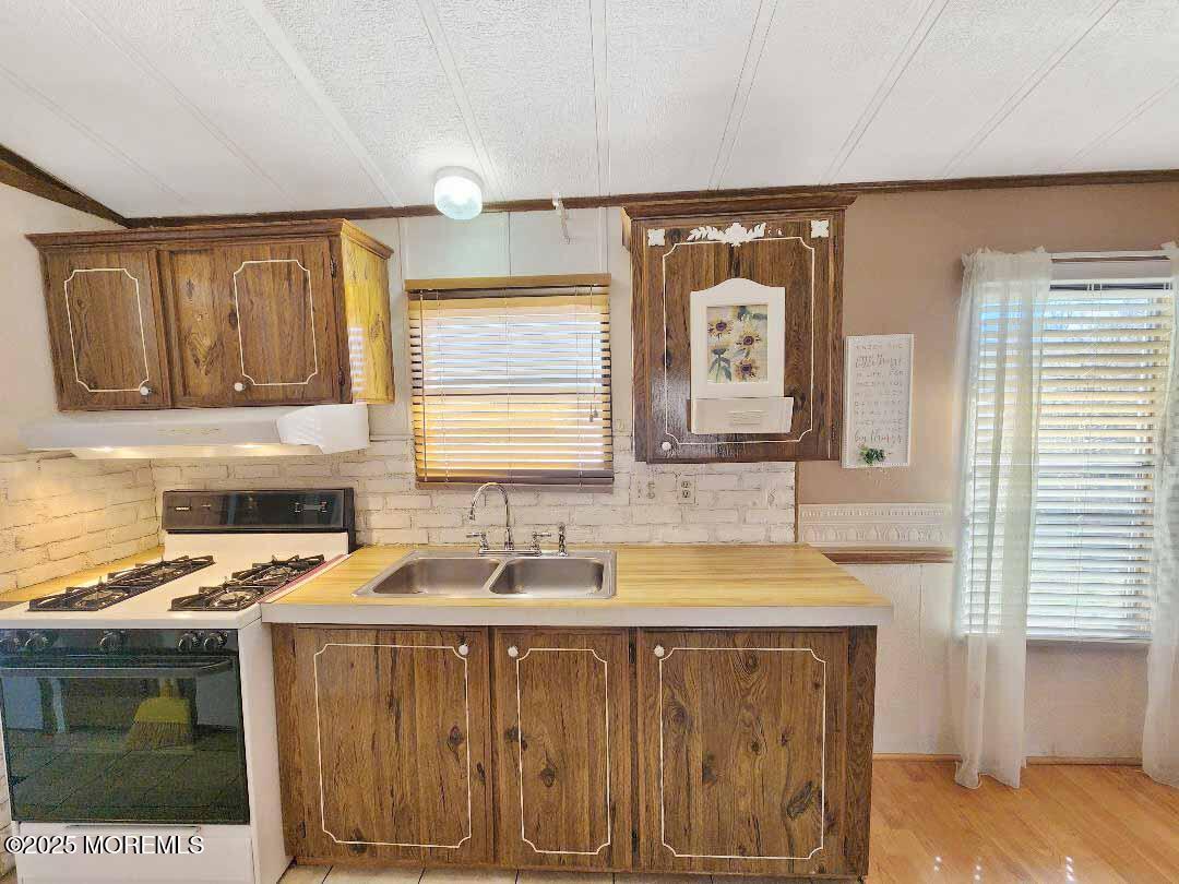 5 Fallow Drive Manalapan, NJ 07726 - Photo 5 of 23 a kitchen with a sink stove and cabinets