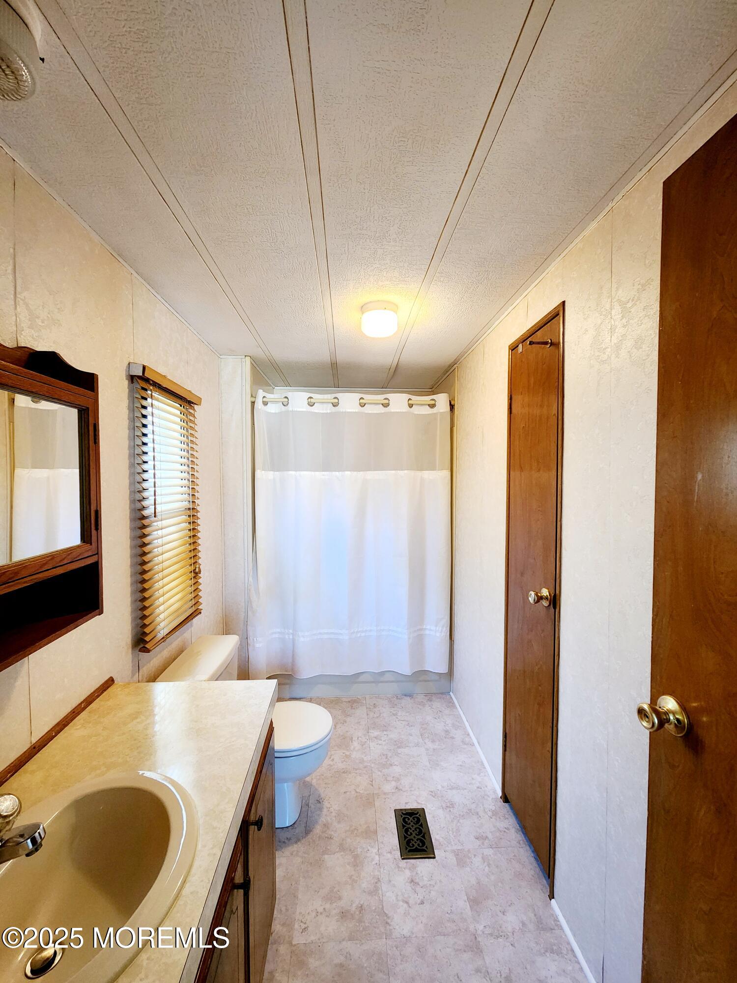 5 Fallow Drive Manalapan, NJ 07726 - Photo 8 of 23 a bathroom with a granite countertop sink and a mirror