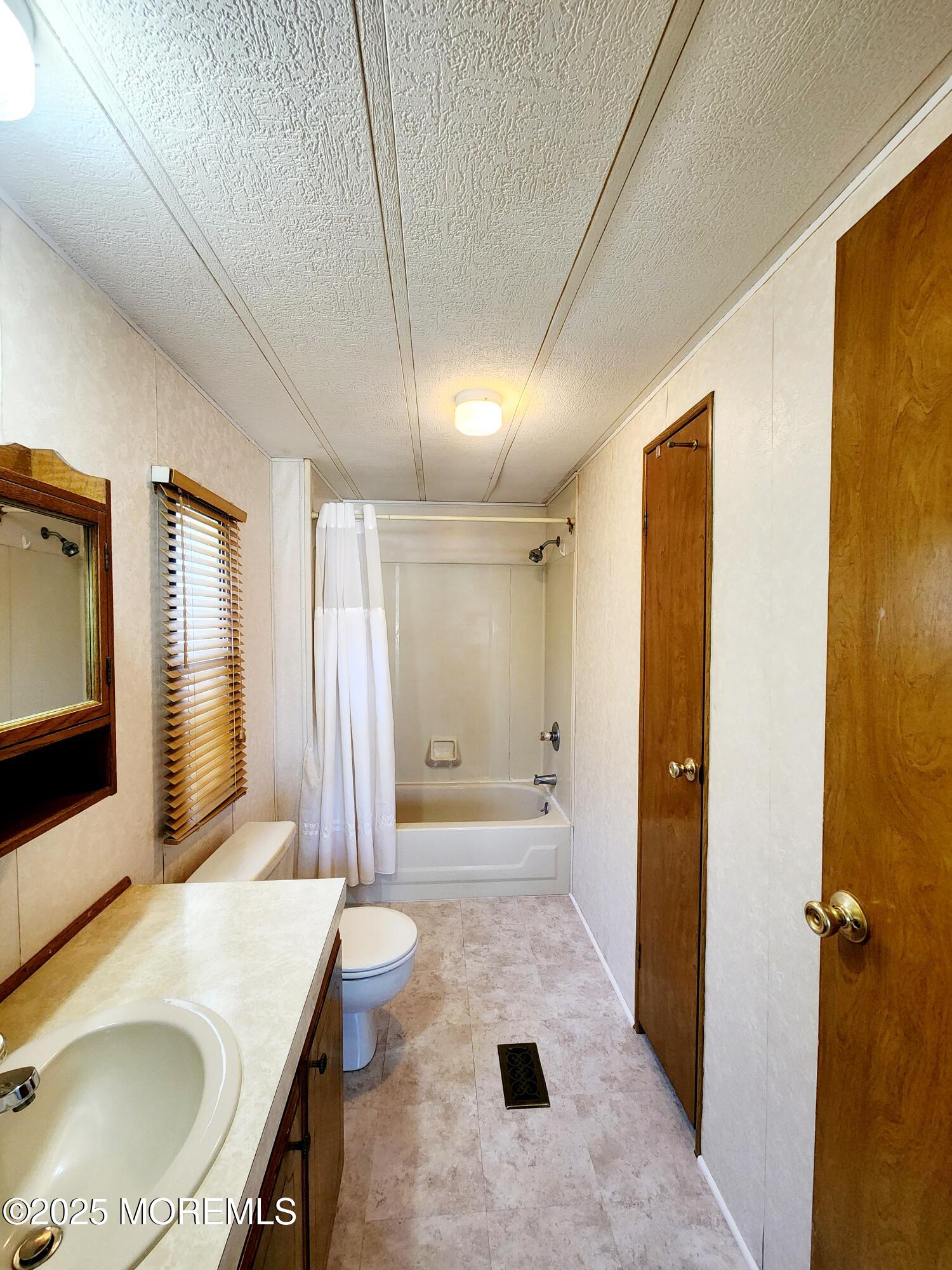 5 Fallow Drive Manalapan, NJ 07726 - Photo 9 of 23 a bathroom with a sink a toilet and shower