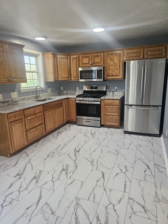 40 Merrick Street, Unit A Worcester, MA 01609 - Photo 32 of 32 a kitchen with stainless steel appliances granite countertop a refrigerator sink and stove