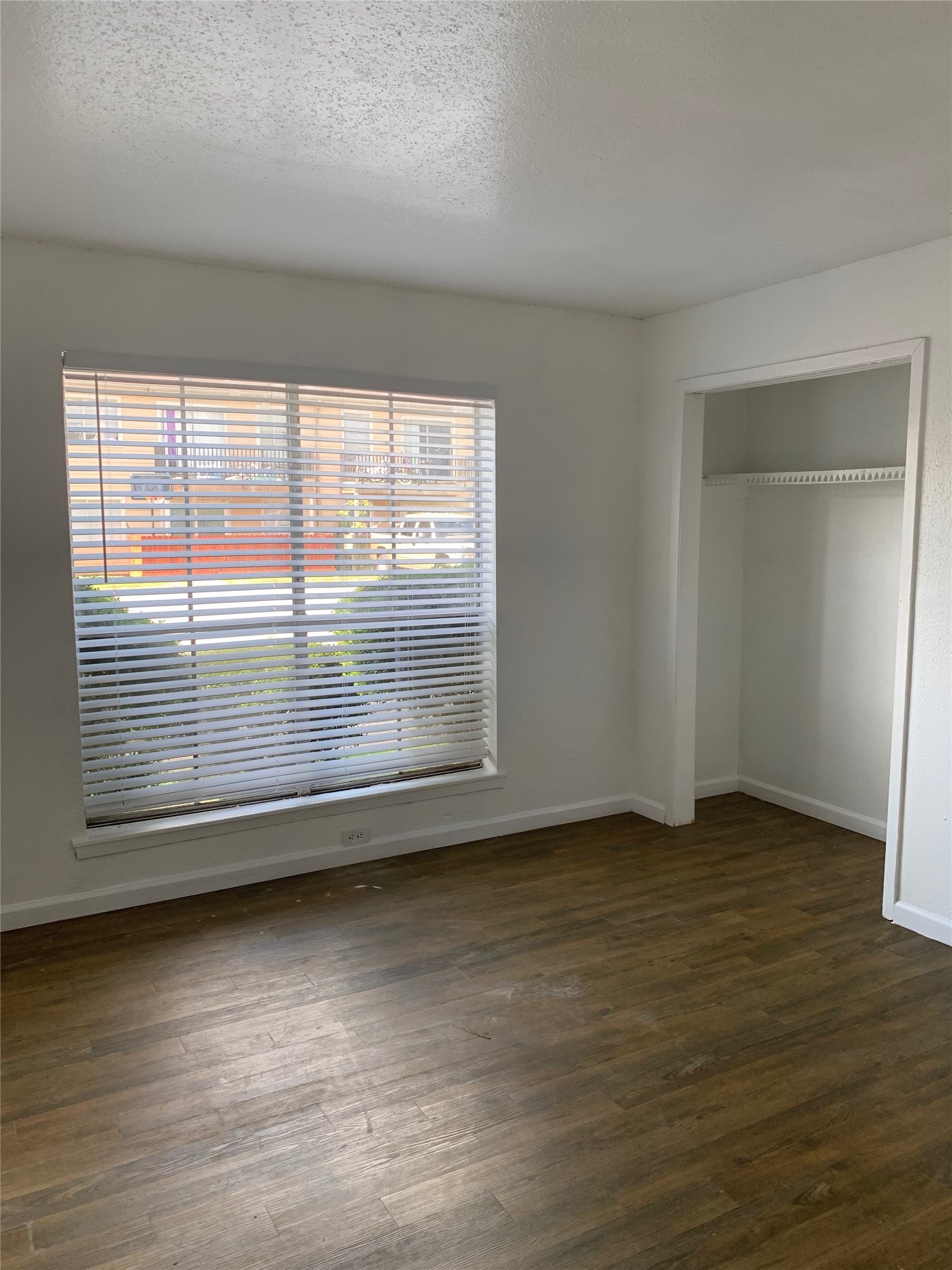 6200 West Tidwell Road, Unit 2701 Houston, TX 77092 - Photo 7 of 10 an empty room with wooden floor and windows