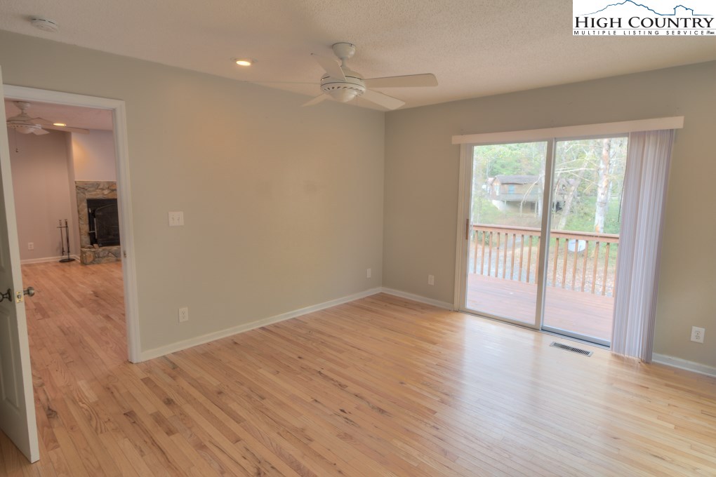 305 Signal Tree Road Deep Gap, NC 28618 - Photo 11 of 33 wooden floor in an empty room with a window