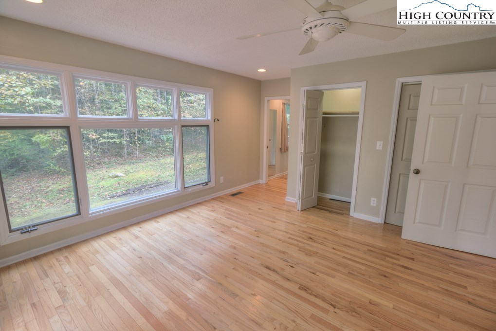 305 Signal Tree Road Deep Gap, NC 28618 - Photo 12 of 33 a view of empty room with wooden floor and fan