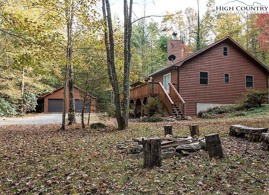 305 Signal Tree Road Deep Gap, NC 28618 - Photo 25 of 33 a backyard of a house with table and chairs