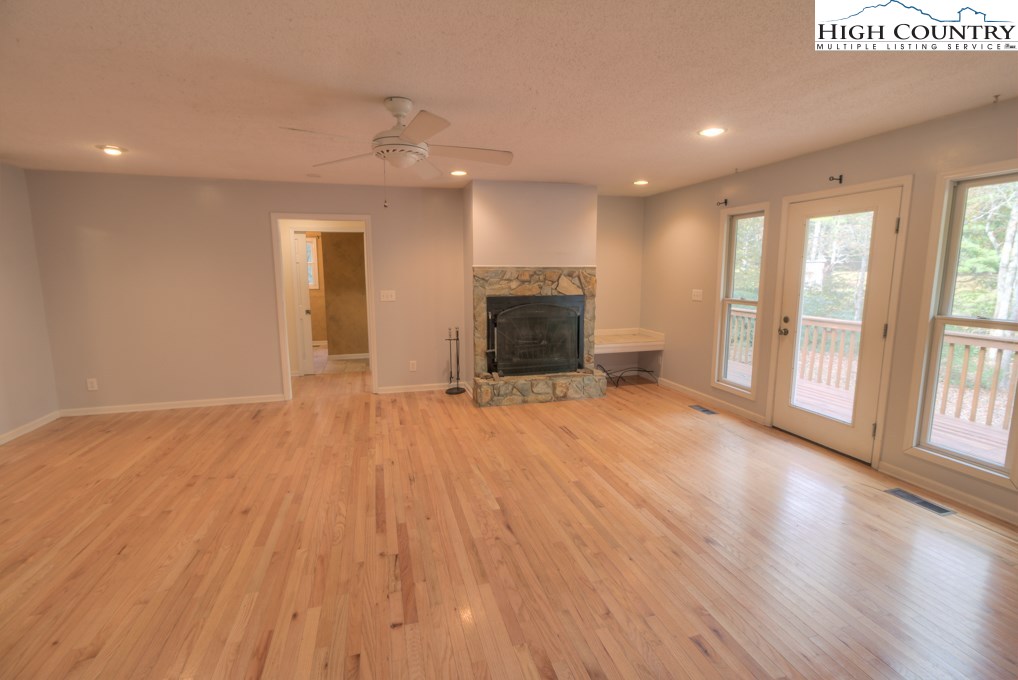 305 Signal Tree Road Deep Gap, NC 28618 - Photo 5 of 33 a view of an empty room with wooden floor and a window