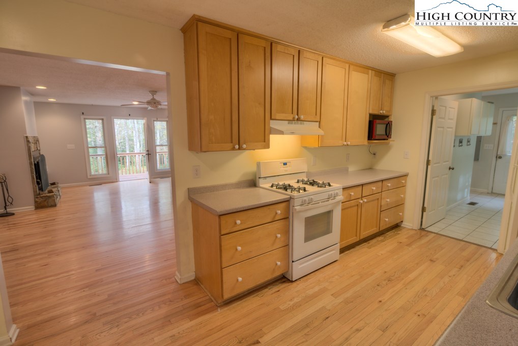 305 Signal Tree Road Deep Gap, NC 28618 - Photo 8 of 33 a kitchen with stainless steel appliances granite countertop a stove a sink and a refrigerator