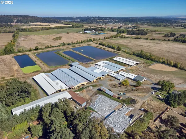 an aerial view of ocean and residential houses with outdoor space