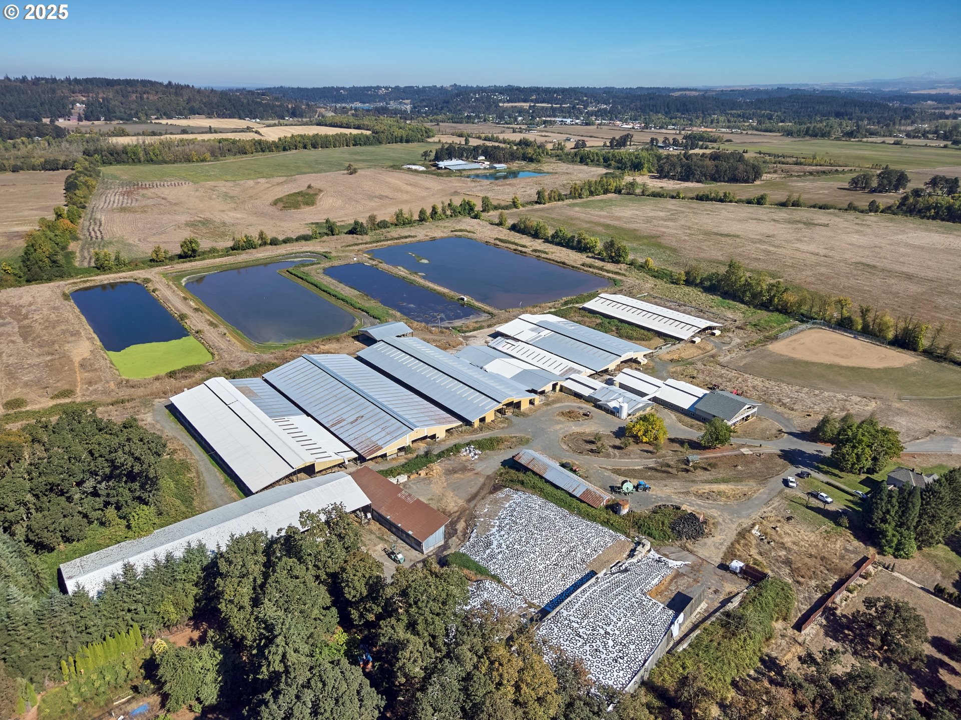 an aerial view of ocean and residential houses with outdoor space