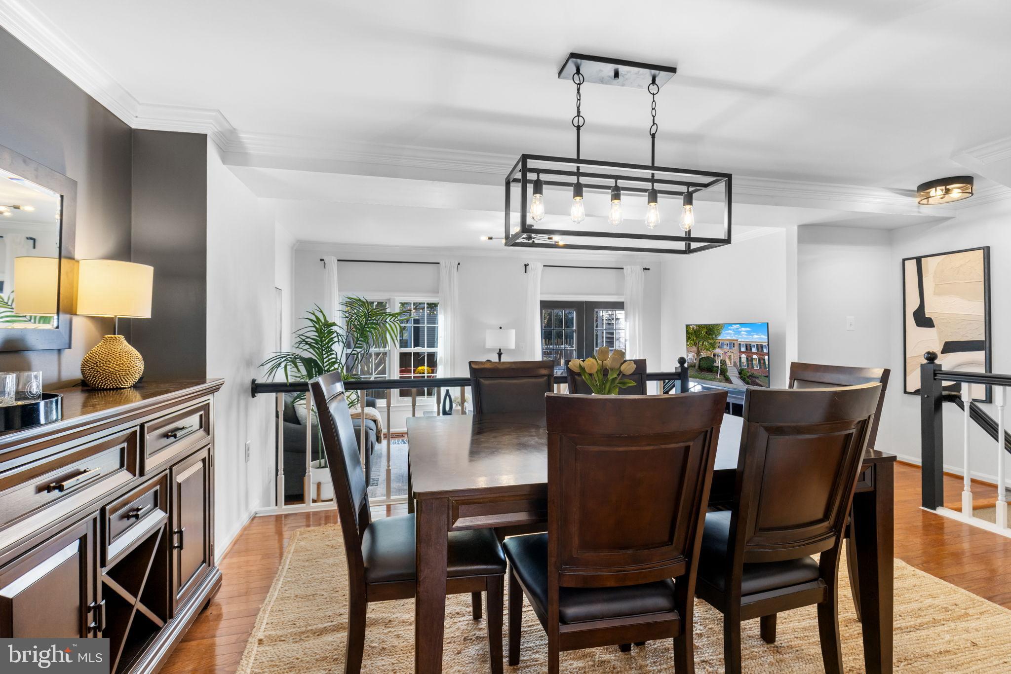 6223 Walkers Croft Way Alexandria, VA 22315 - Photo 11 of 38 a view of a dining room with furniture a chandelier and wooden floor