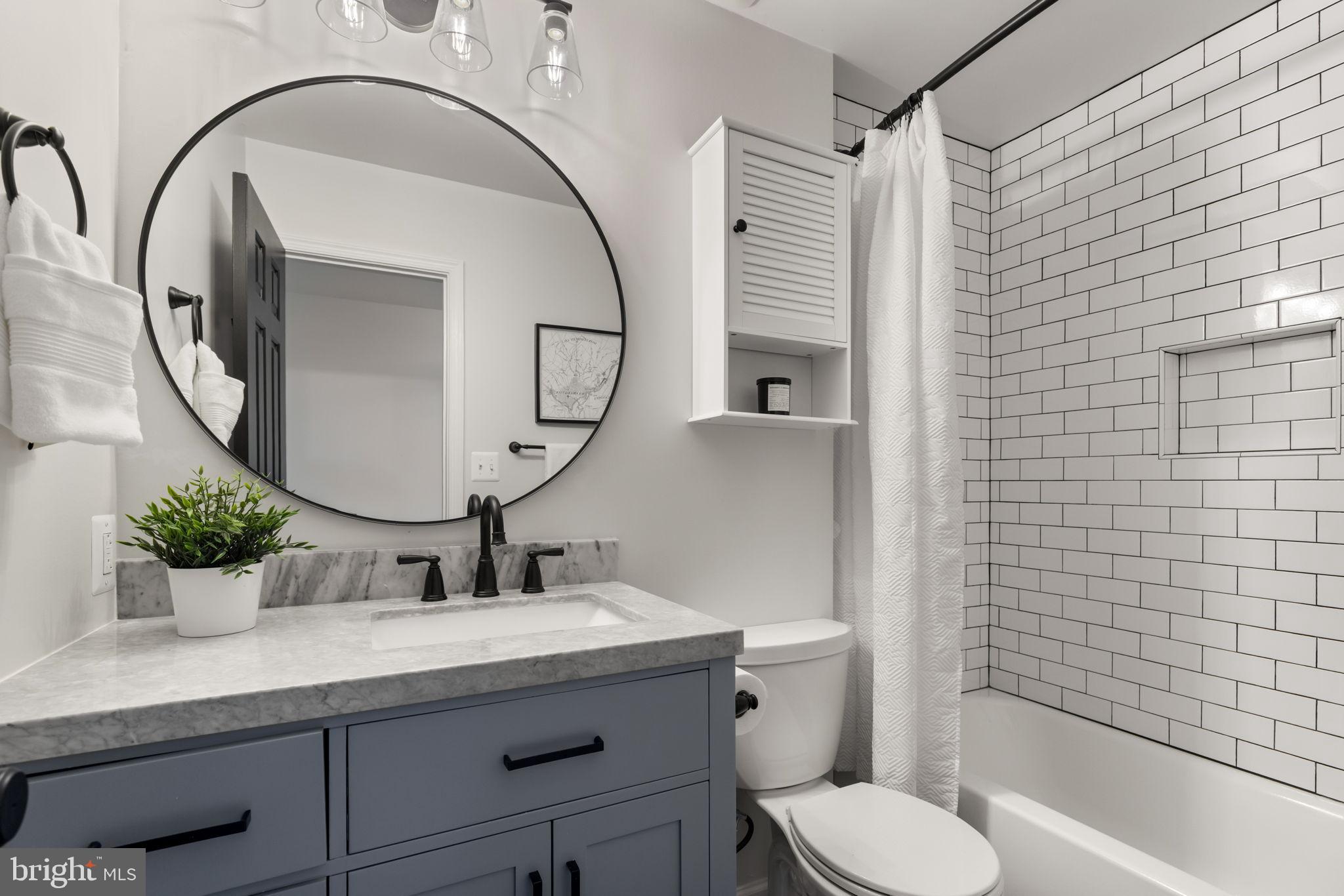 6223 Walkers Croft Way Alexandria, VA 22315 - Photo 28 of 38 a bathroom with a granite countertop toilet sink and mirror