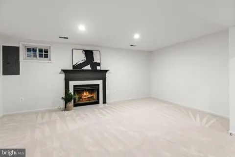a view of an empty room with a fireplace