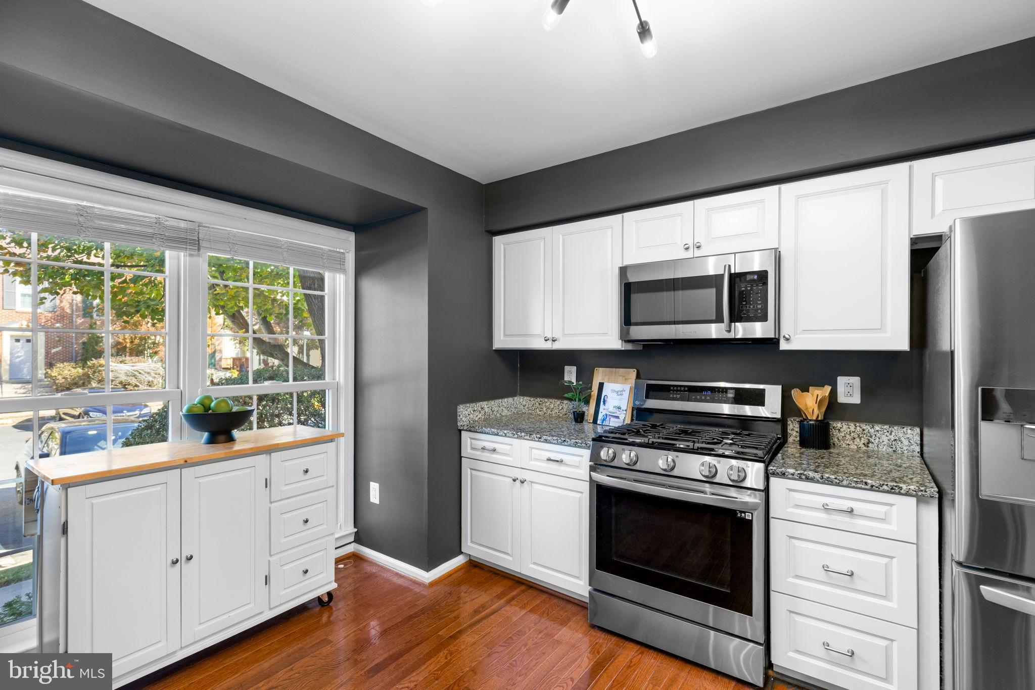 6223 Walkers Croft Way Alexandria, VA 22315 - Photo 7 of 38 a kitchen with white cabinets appliances a sink and a window