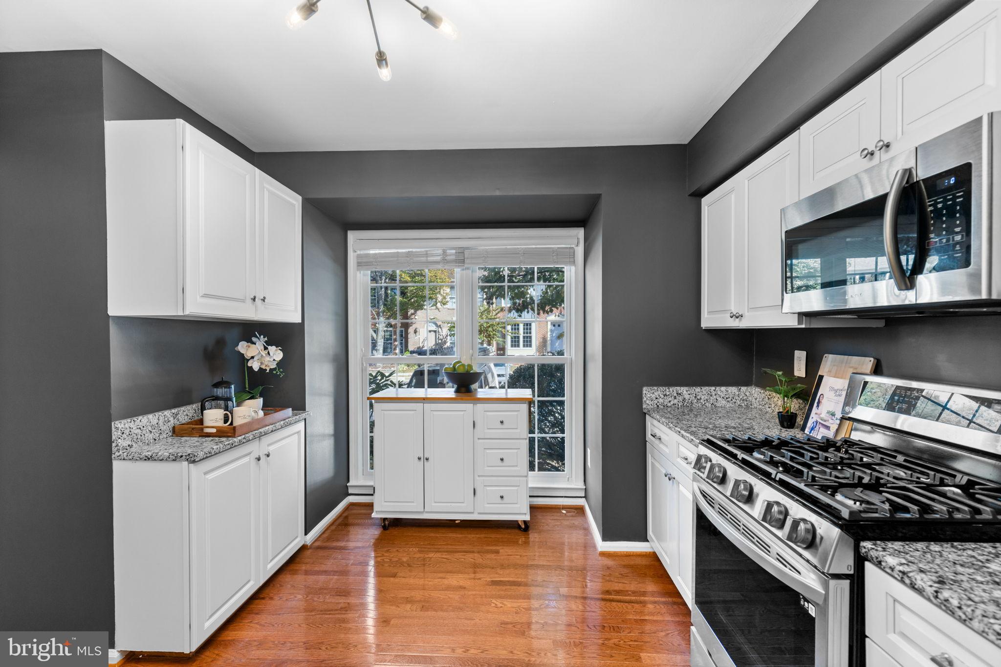 6223 Walkers Croft Way Alexandria, VA 22315 - Photo 8 of 38 a kitchen with stainless steel appliances granite countertop a stove a sink and a microwave