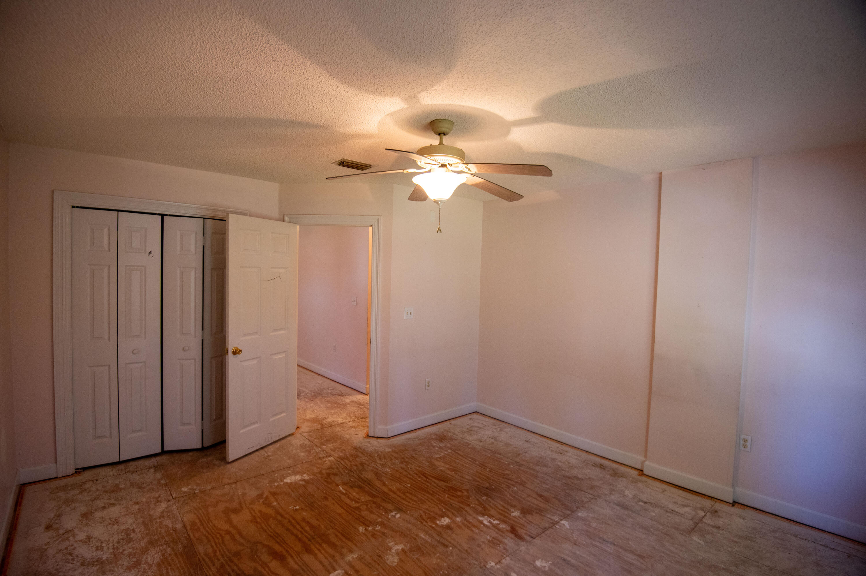 407 Calle Escada Santa Rosa Beach, FL 32459 - Photo 17 of 17 an empty room with closet and a chandelier fan