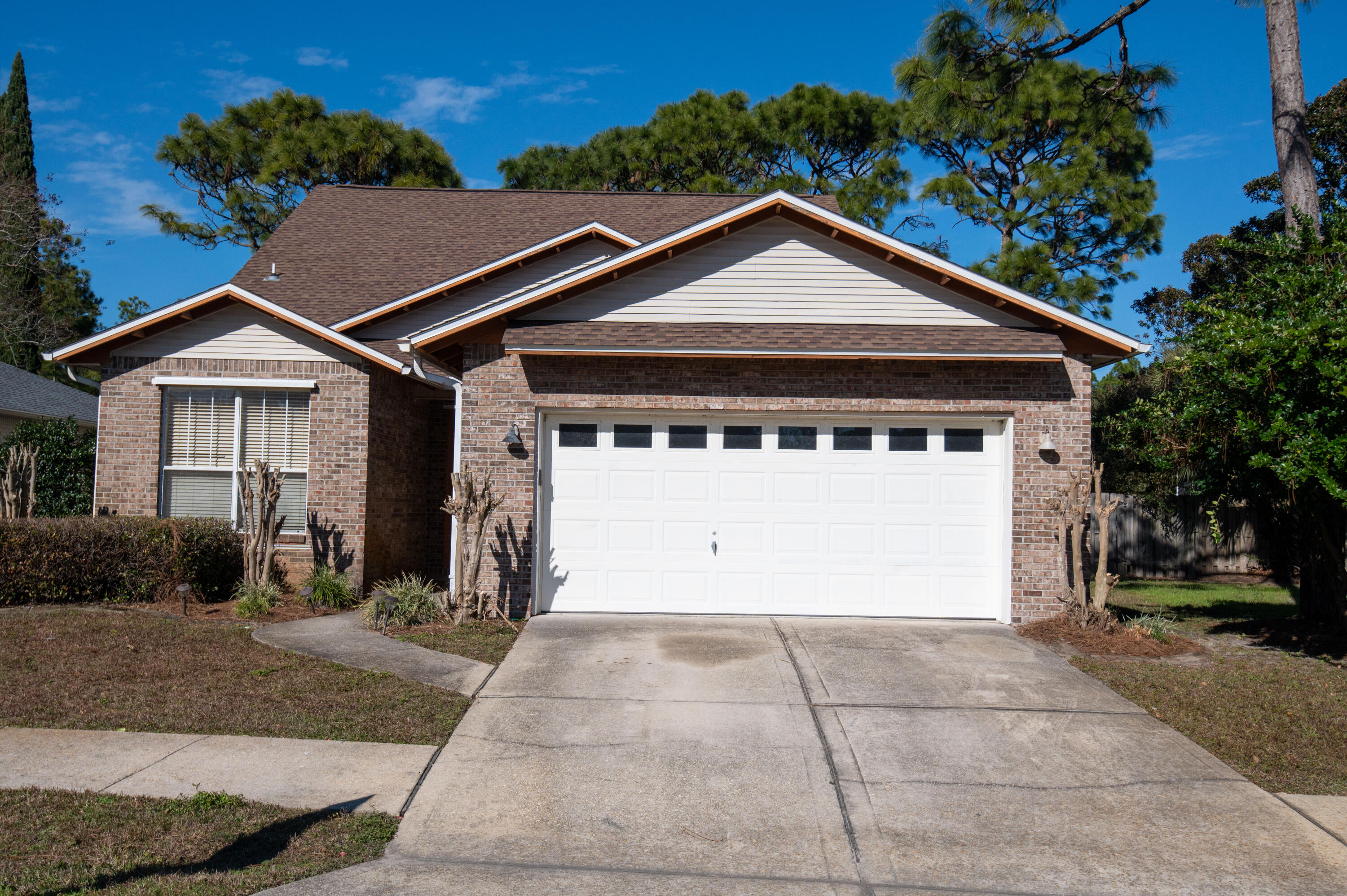 407 Calle Escada Santa Rosa Beach, FL 32459 - Photo 2 of 17 a front view of a house with a yard and garage