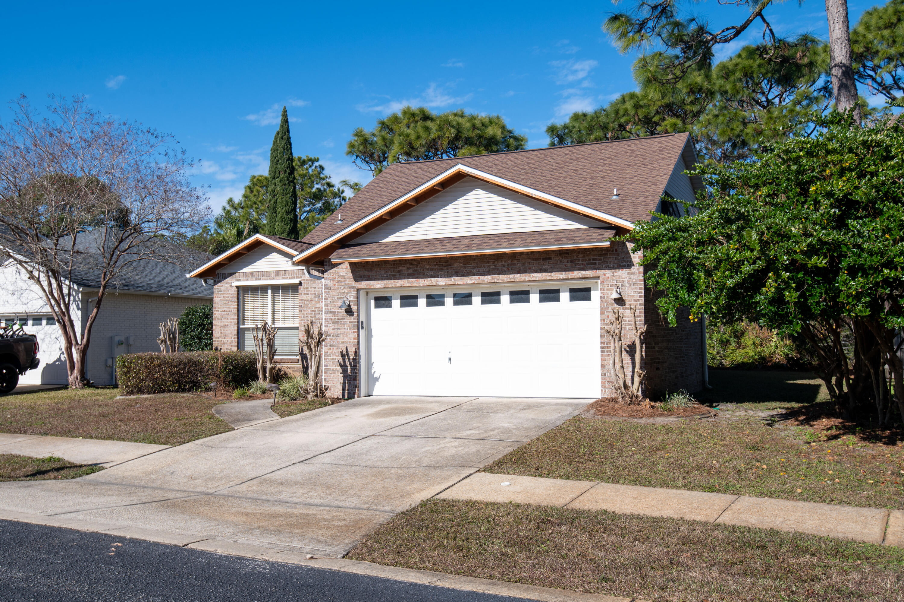 407 Calle Escada Santa Rosa Beach, FL 32459 - Photo 3 of 17 a front view of a house with a yard and garage