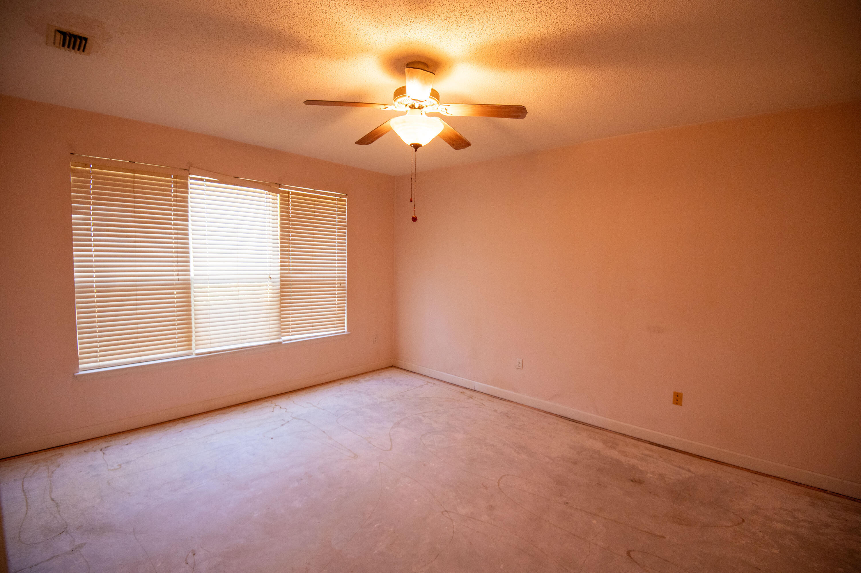 407 Calle Escada Santa Rosa Beach, FL 32459 - Photo 10 of 17 an empty room with a chandelier fan and windows