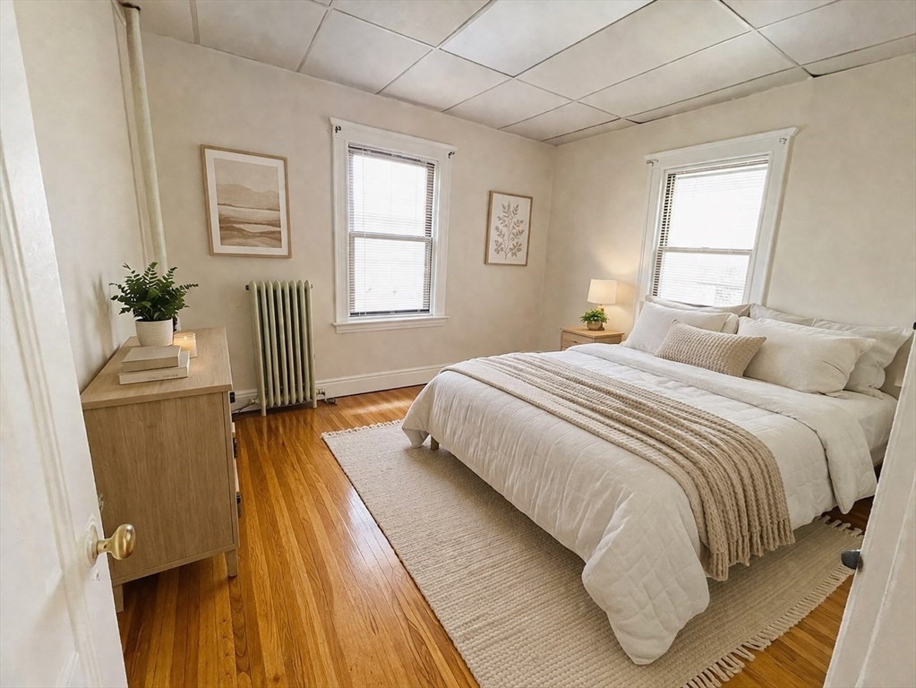 5 Feneno Terrace, Unit 1 Boston, MA 02134 - Photo 3 of 5 a bedroom with a bed and wooden floor