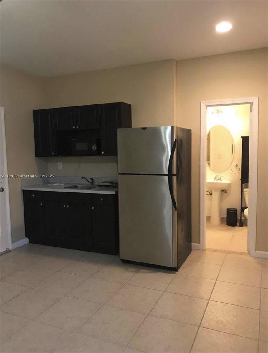 14131 Southwest 276th Street Homestead, FL 33032 - Photo 2 of 6 a kitchen with stainless steel appliances granite countertop a refrigerator and a stove