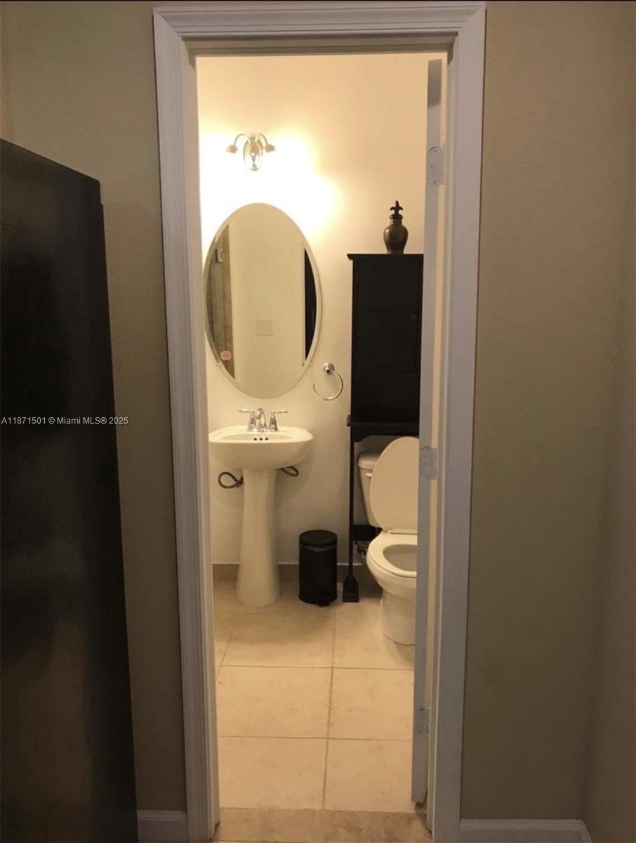 14131 Southwest 276th Street Homestead, FL 33032 - Photo 5 of 6 a bathroom with a toilet and a sink