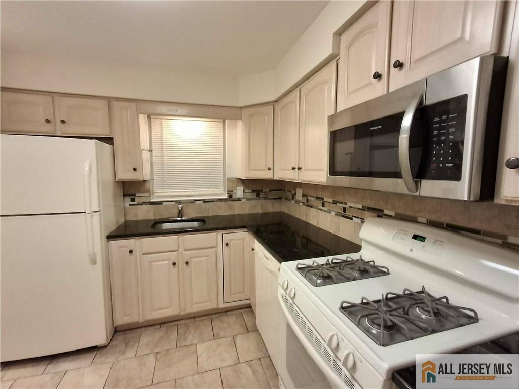 363 Cranbury Road, Unit A3 East Brunswick, NJ 08816 - Photo 2 of 16 a kitchen with a sink a stove and refrigerator