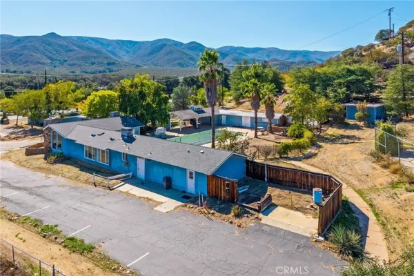 a view of a house with snow on the road