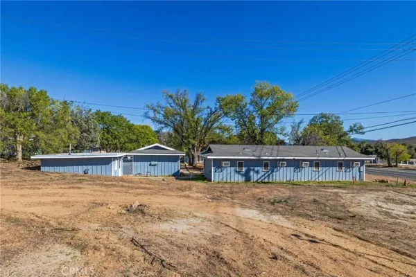 a view of a house with yard and sitting area