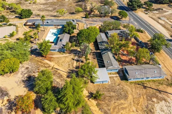 an aerial view of residential houses with outdoor space and street view