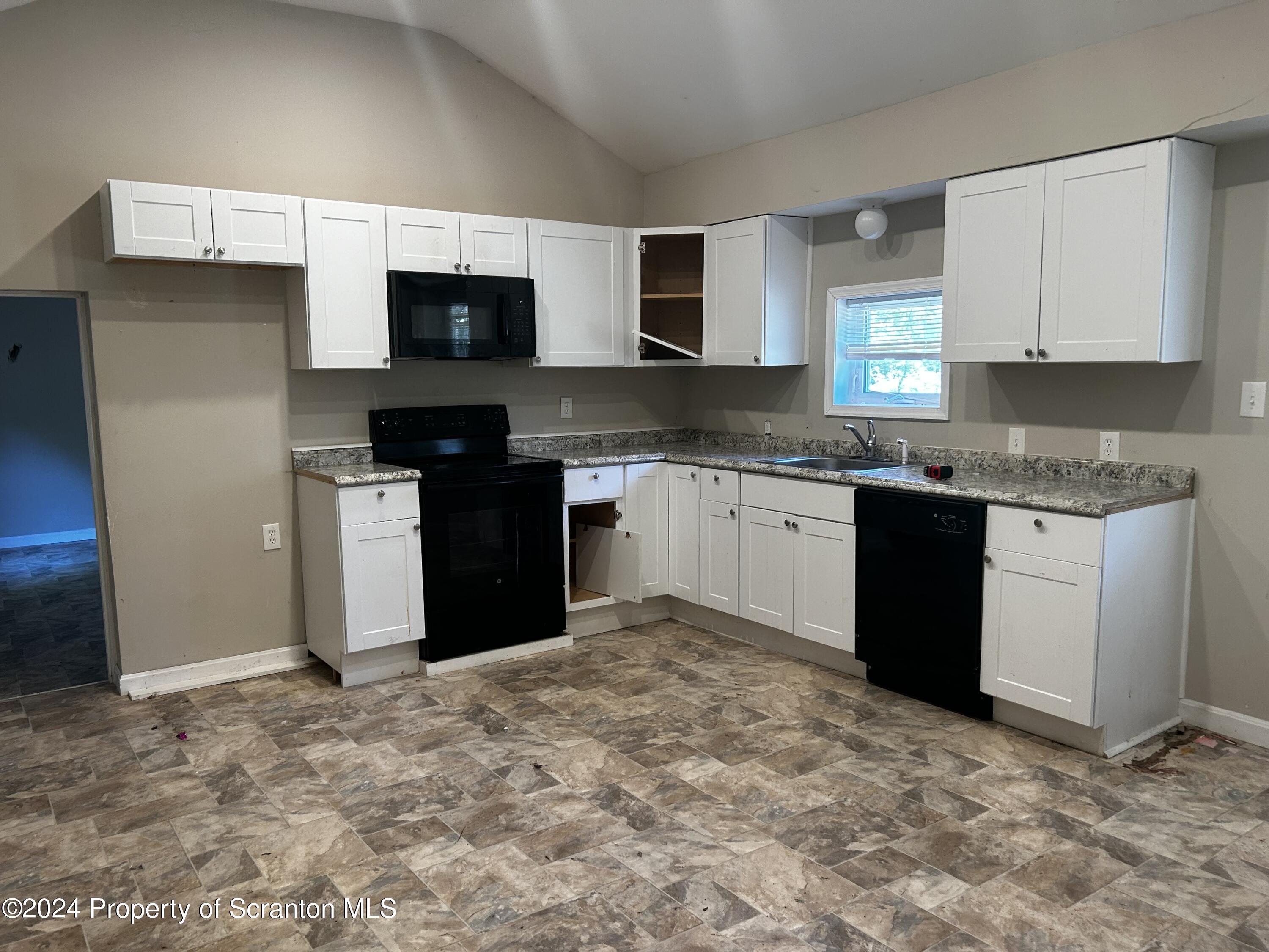 3611 Aberdeen Road Moscow, PA 18444 - Photo 8 of 24 a kitchen with stainless steel appliances granite countertop a stove top oven a sink and a microwave