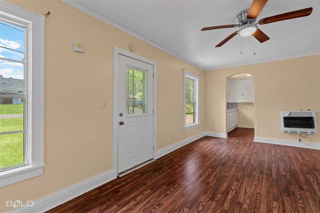 115 Pam Street Mansfield, LA 71052 - Photo 3 of 25 a view of empty room with wooden floor and fan