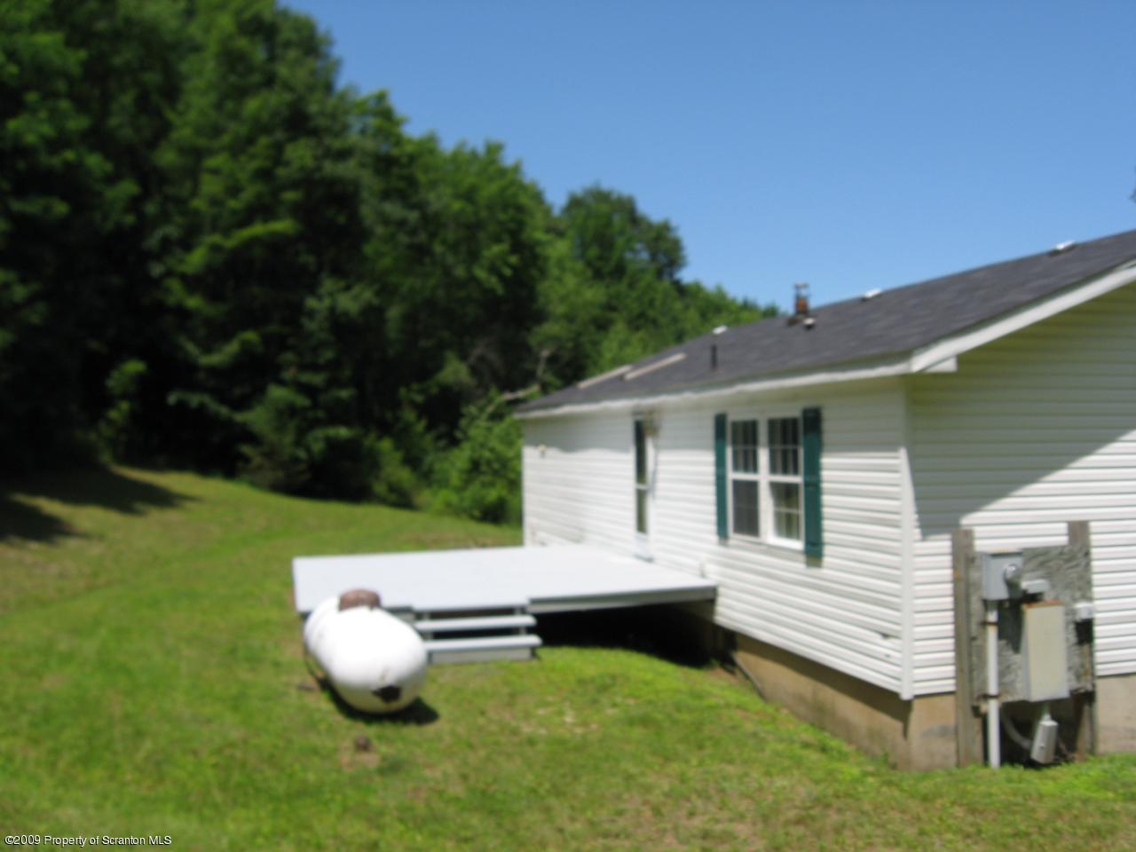 Bass Road Rd Falls Falls, PA 18615 - Photo 4 of 6 a view of a house with backyard and sitting area