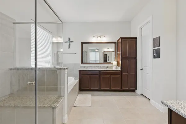 a bathroom with a bathtub and a shower