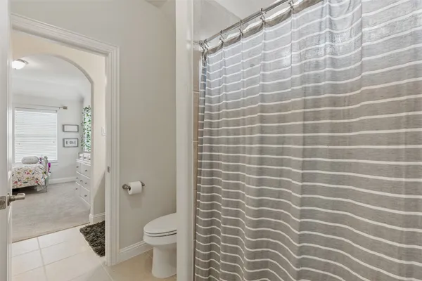 a bathroom with a granite countertop sink a mirror and a shower