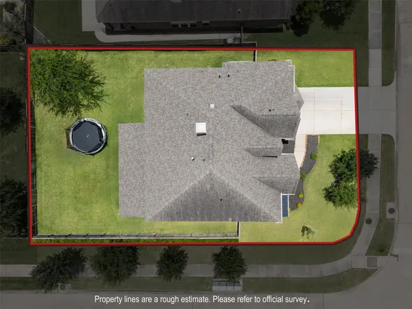 an aerial view of residential houses with outdoor space and lake view