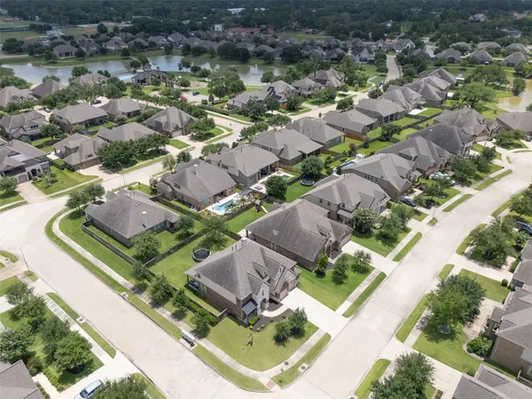 an aerial view of residential houses with outdoor space and parking
