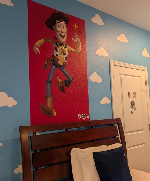 2800 Simile Street Kissimmee, FL 34746 - Photo 16 of 62 a room with red wall paintings and a painting on the wall