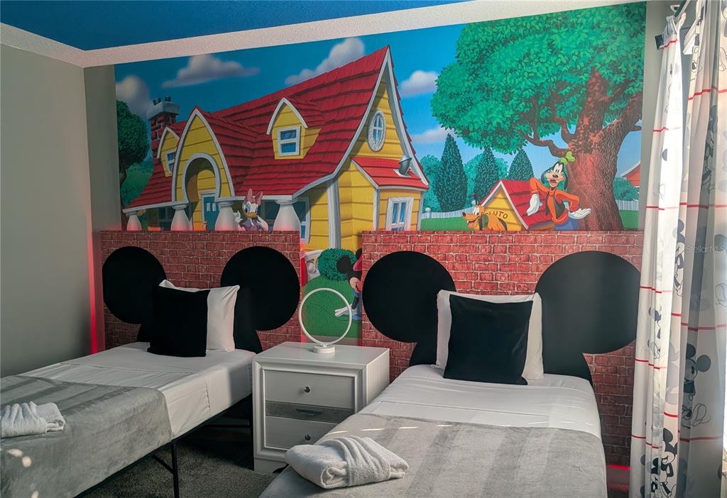 2800 Simile Street Kissimmee, FL 34746 - Photo 24 of 62 a living room with furniture a rug and a wall painting