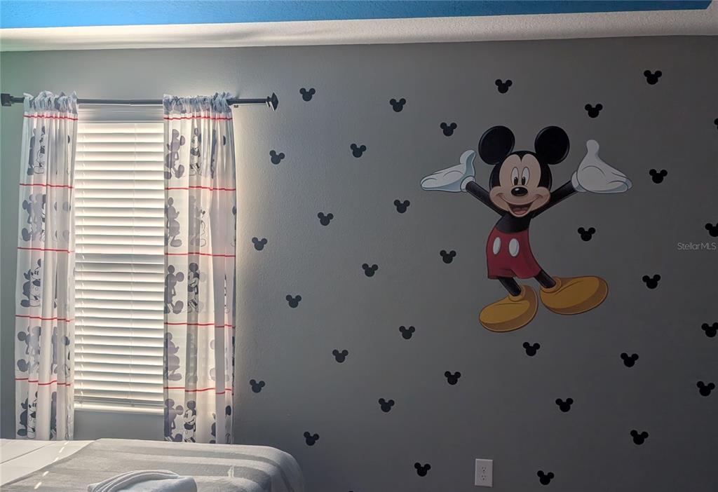 2800 Simile Street Kissimmee, FL 34746 - Photo 25 of 62 a bedroom with a bed and a chandelier