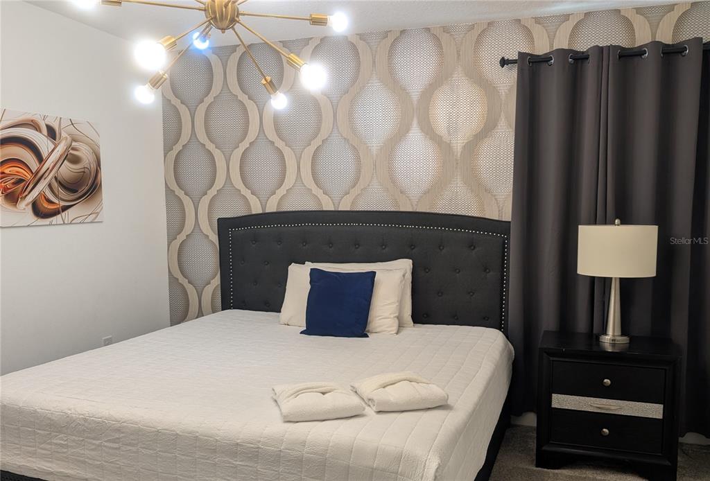 2800 Simile Street Kissimmee, FL 34746 - Photo 31 of 62 a bedroom with a bed and a lamp