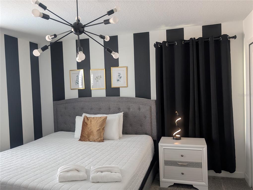 2800 Simile Street Kissimmee, FL 34746 - Photo 37 of 62 a bedroom with a bed dresser and a window