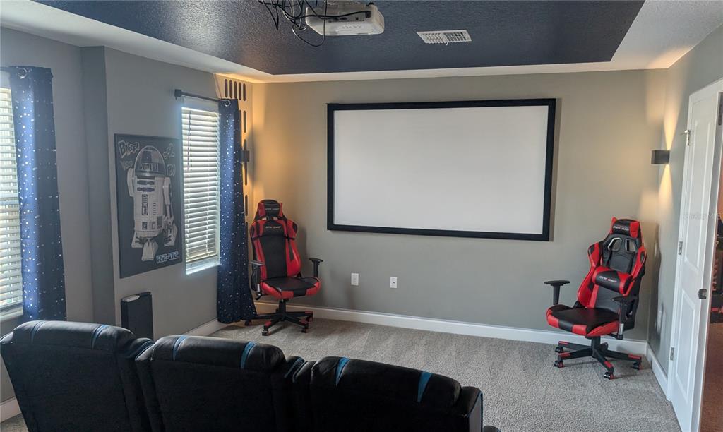 2800 Simile Street Kissimmee, FL 34746 - Photo 40 of 62 a living room with a couch and a flat screen tv