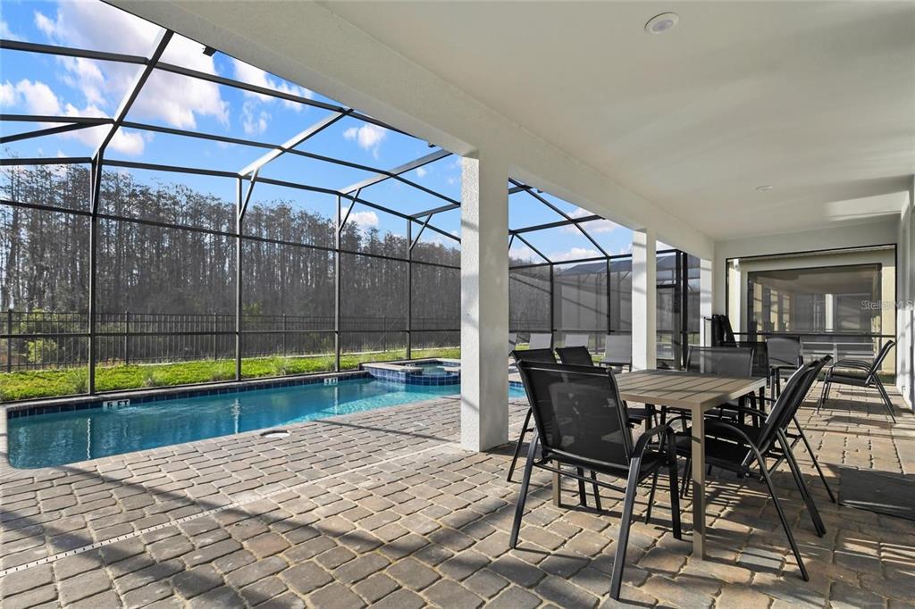 2800 Simile Street Kissimmee, FL 34746 - Photo 48 of 62 a view of a backyard with a swimming pool and sitting area