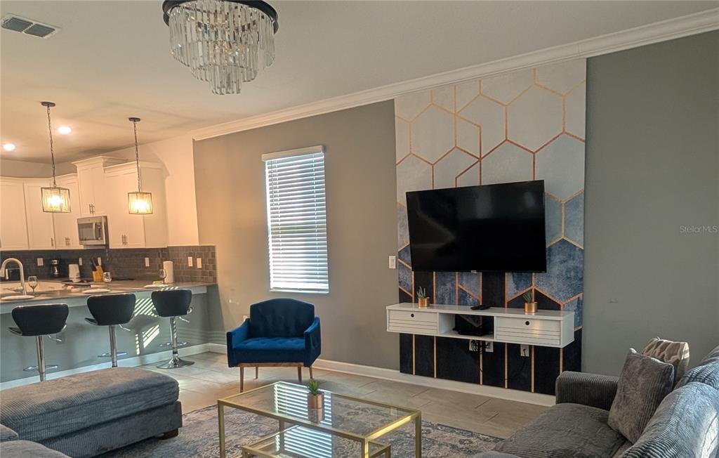 2800 Simile Street Kissimmee, FL 34746 - Photo 8 of 62 a living room with furniture and a flat screen tv